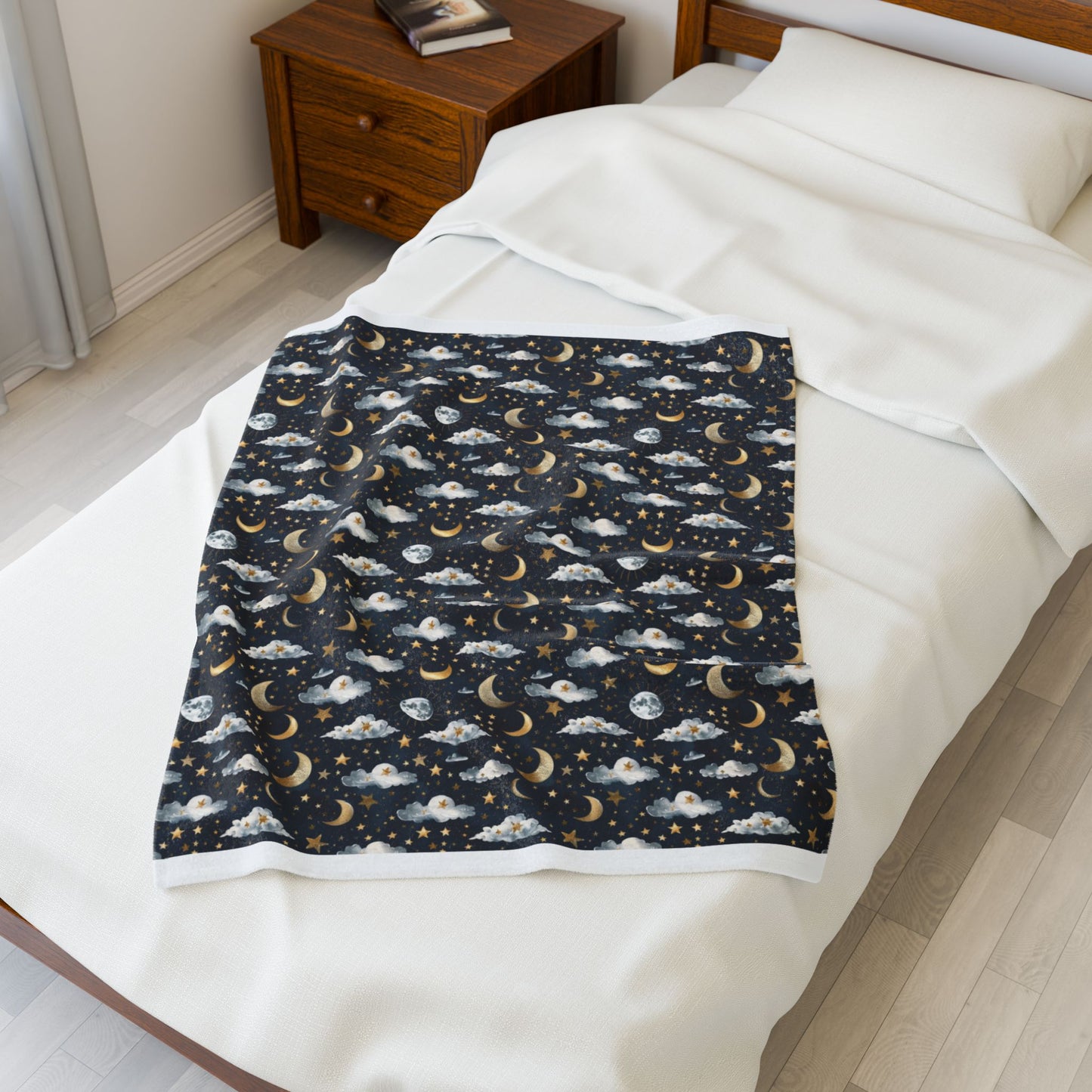 Blanket with celestial pattern on a bed in a bedroom setting