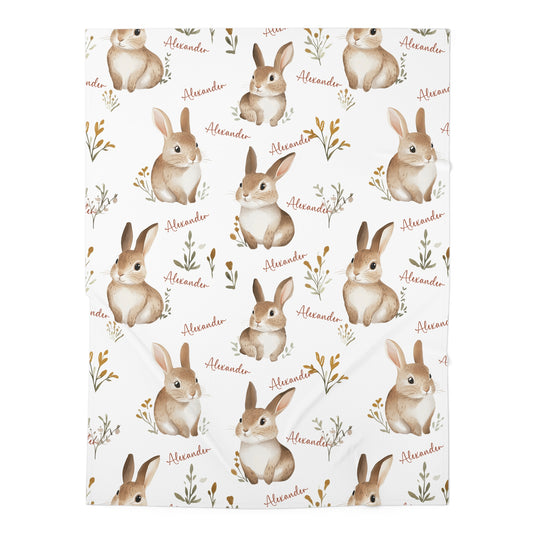 Patterned paper with illustrations of rabbits and the name 'Alexander' on a white background
